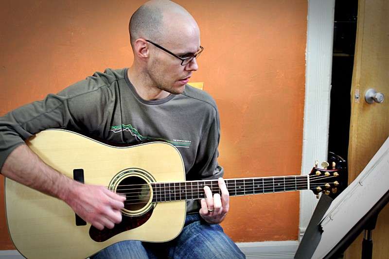 Student Chris playing guitar at Make Great Music