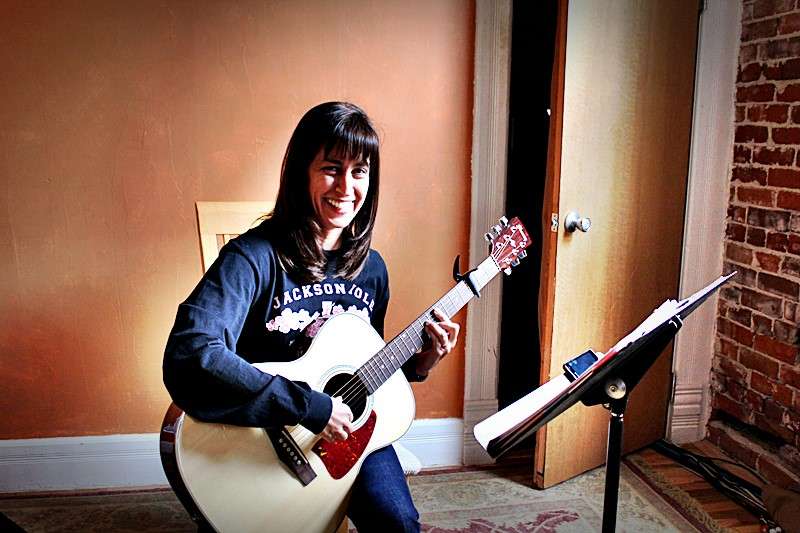 Student Veronica playing guitar